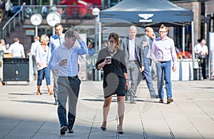 Business people walking on the Canary Wharf square. London, UK