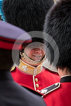Two Royal Guard soldiers having a friendly chat during the Trooping the Colour military parade, London UK