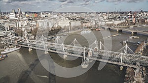 London under a moody sky. London Eye with view of Big Ben across the river Thames with sepia skyscape.