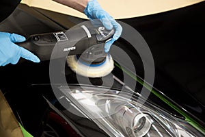 LONDON, UNITED KINGDOM - Feb 17, 2017: Detailer using Rupes rotary machine polishing a sports car