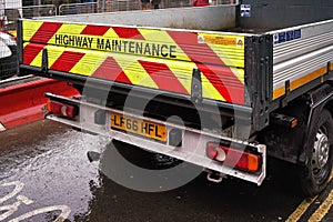 London, United Kingdom - February 01, 2019: Highway maintenance lorry truck standing on wet asphalt road near construction site,