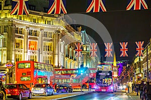 London, United Kingdom - June 18, 2016: Oxford street by night, with flags and Londodn bus