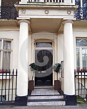 London, vintage house entrance with dark door and columns