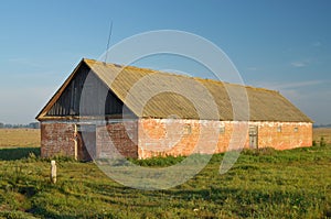 A lone barn in a field.