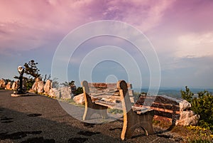 A lone bench faces the mountains under a stormy sunset at High Point State Park