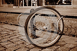 A lone bicycle wheel in a street