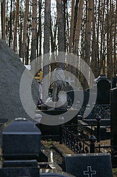 A lone bronze sculpture in the cemetery in memory of the deceased young girl