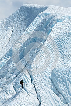 Lone climber looking to the top of glacier