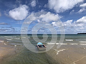 A lone colorful fishing boat in Kamala Phuket Thailand