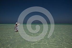 Lone figure on beach in Michamwi-Pingwe Zanzibar,