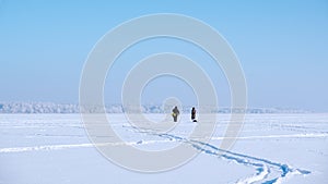 A lone fisherman on a frozen lake. Ice fishing