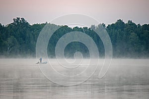 Lone Fisherman On The Lake Before Dawn