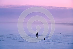 Lone fisherman on winter ice