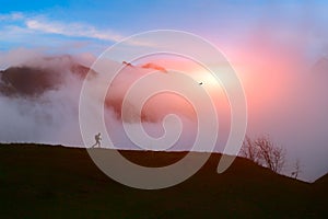 Lone hiker in the mountains at sunset