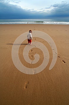 Lone kid on the beach