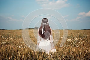 Lone maiden in a summer wheat field