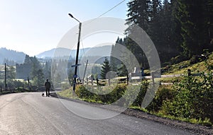 A lone man with a dog run along roads