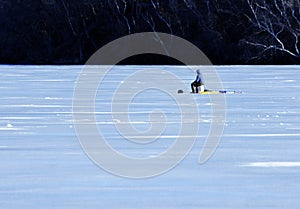 Lone man ice-fishing