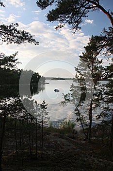 Lone motorboat resting in a Swedish bay, where it\'s completely windstill.