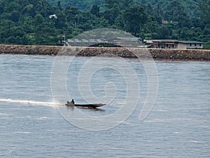 Lone outboard boat on Mekong River taken from Chiang Saen, Thailand