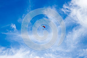 A lone parachutist in the blue sky