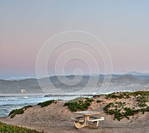 Lone picnic table against the dunes.