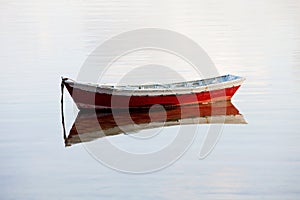 Lone red boat floating