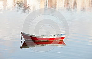 Lone red boat floating