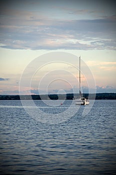 Lone Sailboat with Evening Light On the River