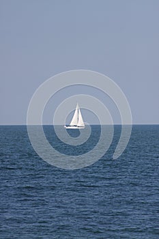 Lone Sailboat at Sea