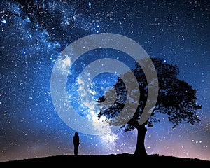 Lone silhouette under a grand oak tree against the Milky Way\'s radiant starlight