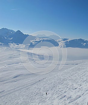 Lone skier on moghul field in Alps photo