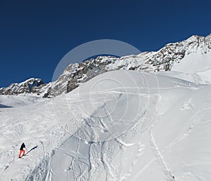 Lone skier sidestepping up ski slope