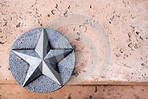 Lone Star of Texas Silver emblem on pink concrete