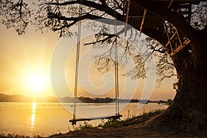 Lone swing at river side and sunset ,Thailand