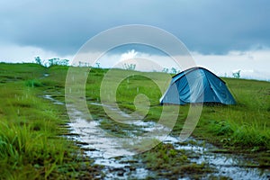 lone tent with rainwater trails on a grassy meadow