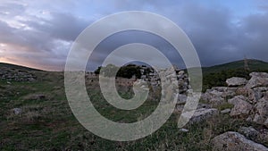 Lone tree blowing in the wind at the top of the ancient Greek Athenian stronghold of Erythrae, Mt Parnitha, Attica, Greece