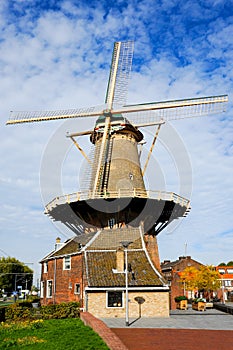 A lone windmill sits in the middle of Delft a small city in the Netherlands.