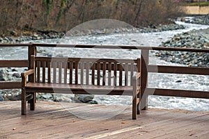 Loneliness concept, empty bench by the river