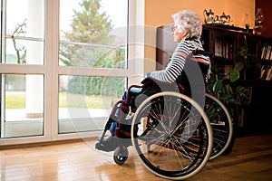 Loneliness senior woman sitting in wheelchair at nursing home