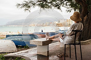 Loneliness woman resting on a chair and looking at the sea