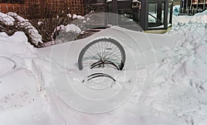 Lonely abandoned bike wheel in the snow