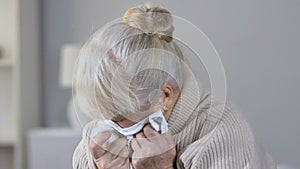 Lonely abandoned depressed elderly woman crying desperately in nursing home