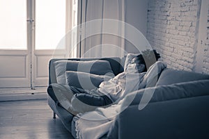 Lonely african american young woman with face mask suffering from depression at home in isolation