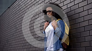 Lonely afro-american schoolgirl standing college backyard, puberty insecurities