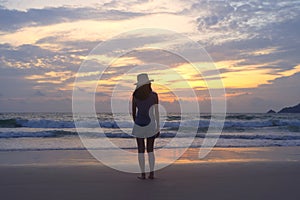 Lonely Asian woman thinking about problems and suffering at the beach during travel holidays vacation outdoors at ocean or nature