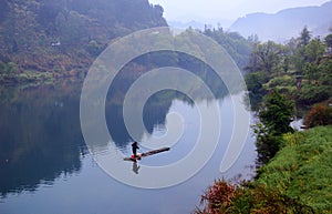 Lonely bamboo rafts floated on the calm lake