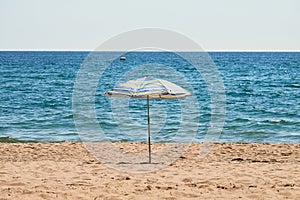 Lonely beach umbrella on the sand.