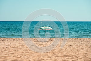 Lonely beach umbrella on the sand.