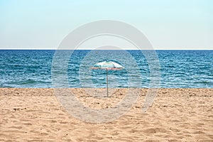 Lonely beach umbrella on the sand.